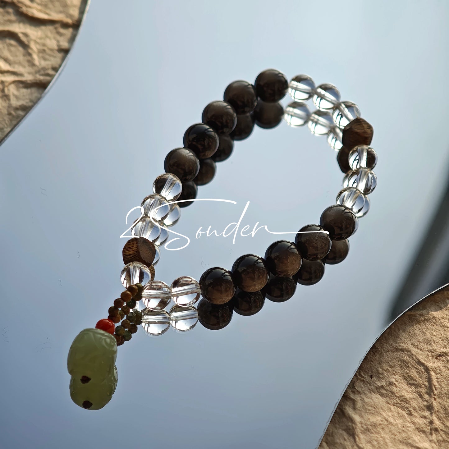 This bracelet combines genuine Silver Obsidian (look for the subtle silver sheen under light), high-clarity White Quartz, and Real Agarwood. Unlike synthetic imitations, our Agarwood carries a faint, natural woody scent that deepens over time. Plus, there is an Agate ring in the bracelet, which adds a touch of classical beauty. It feels grounded and real on your skin.