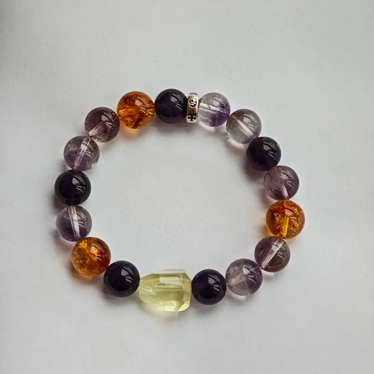 This is an amethyst bracelet including amethyst, citrine, purple rabbit hair quartz and silver spacer.