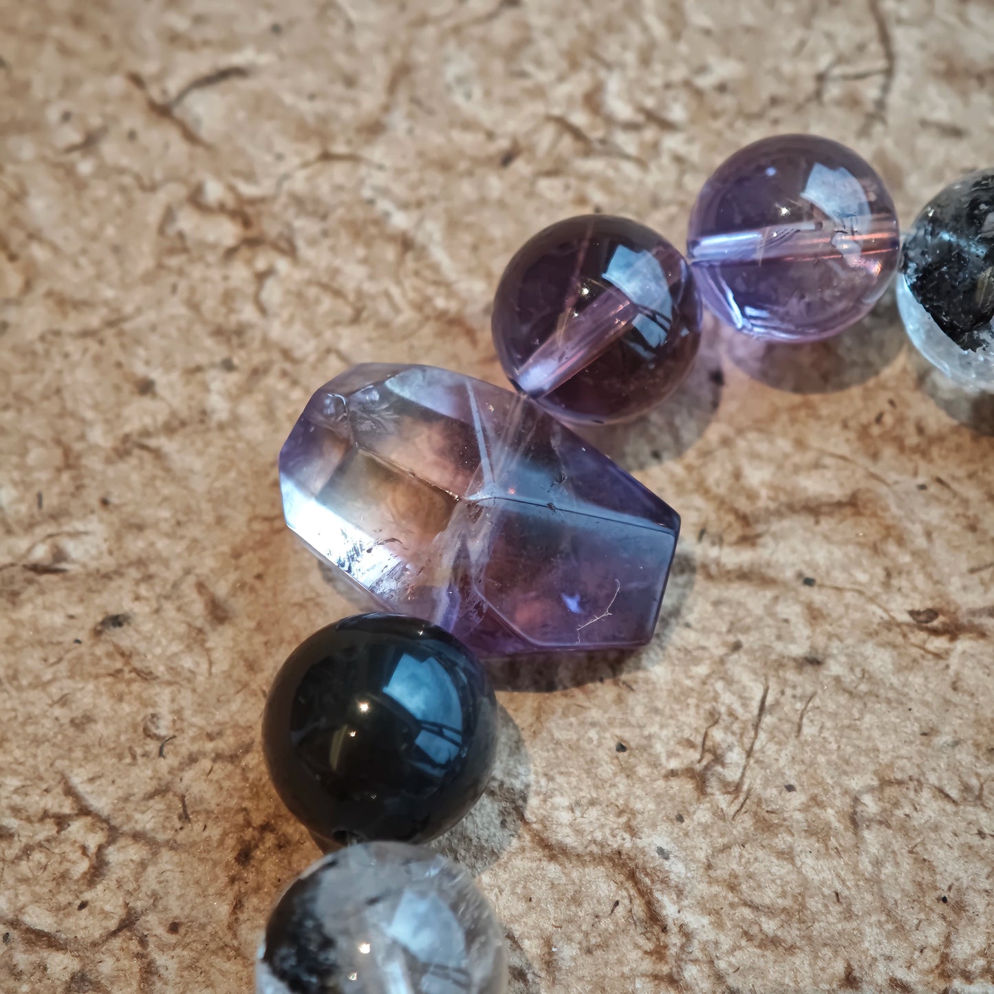 An amethyst bracelet accented with herkimer diamond, clear quartz and silver sheen obsidian.