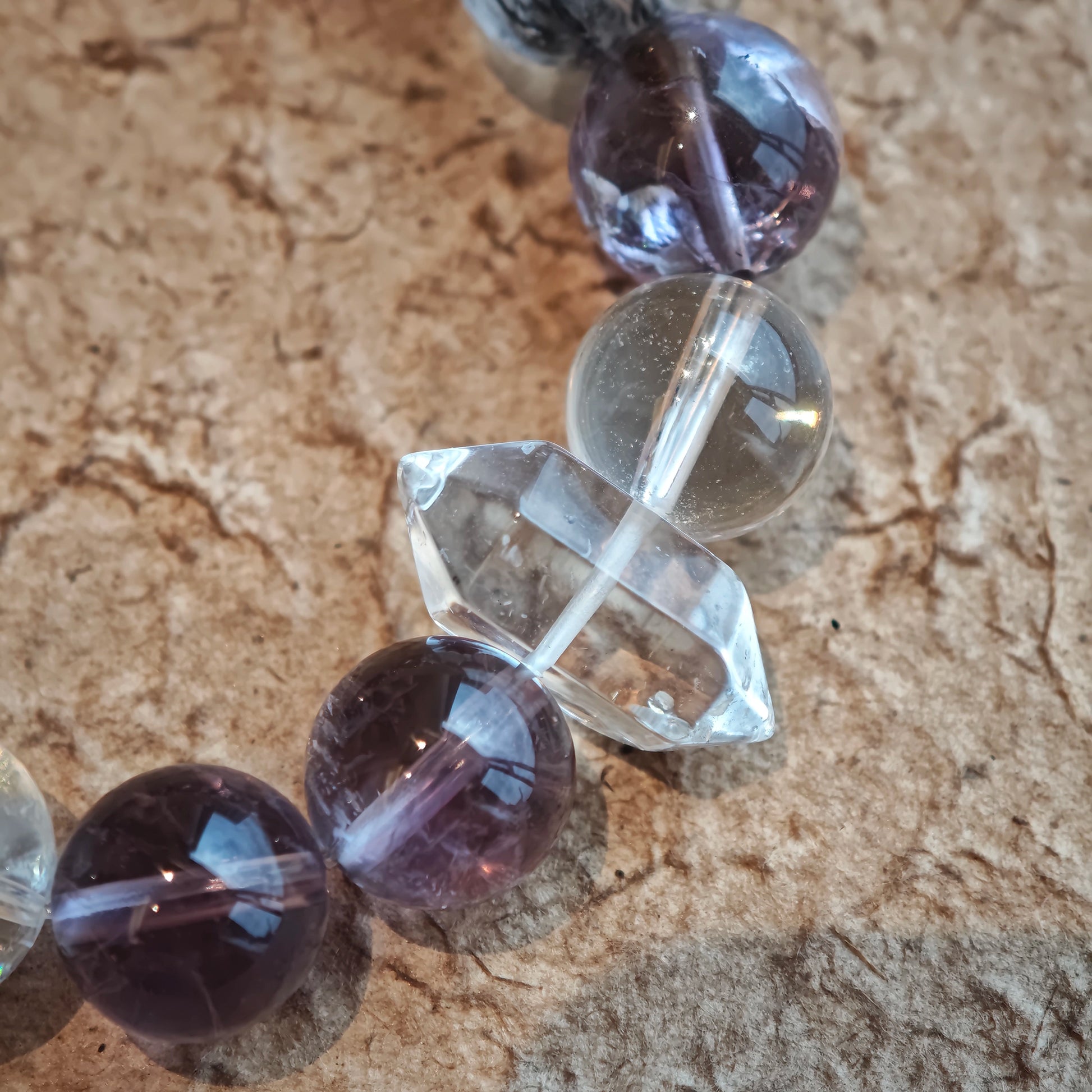 An amethyst bracelet accented with herkimer diamond, clear quartz and silver sheen obsidian.