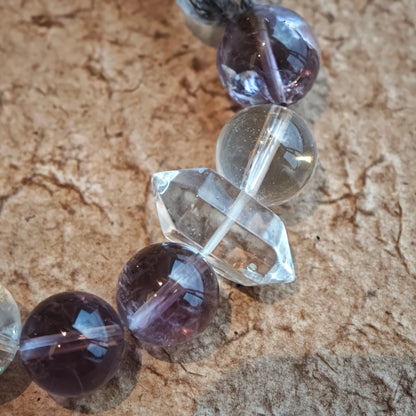 An amethyst bracelet accented with herkimer diamond, clear quartz and silver sheen obsidian.