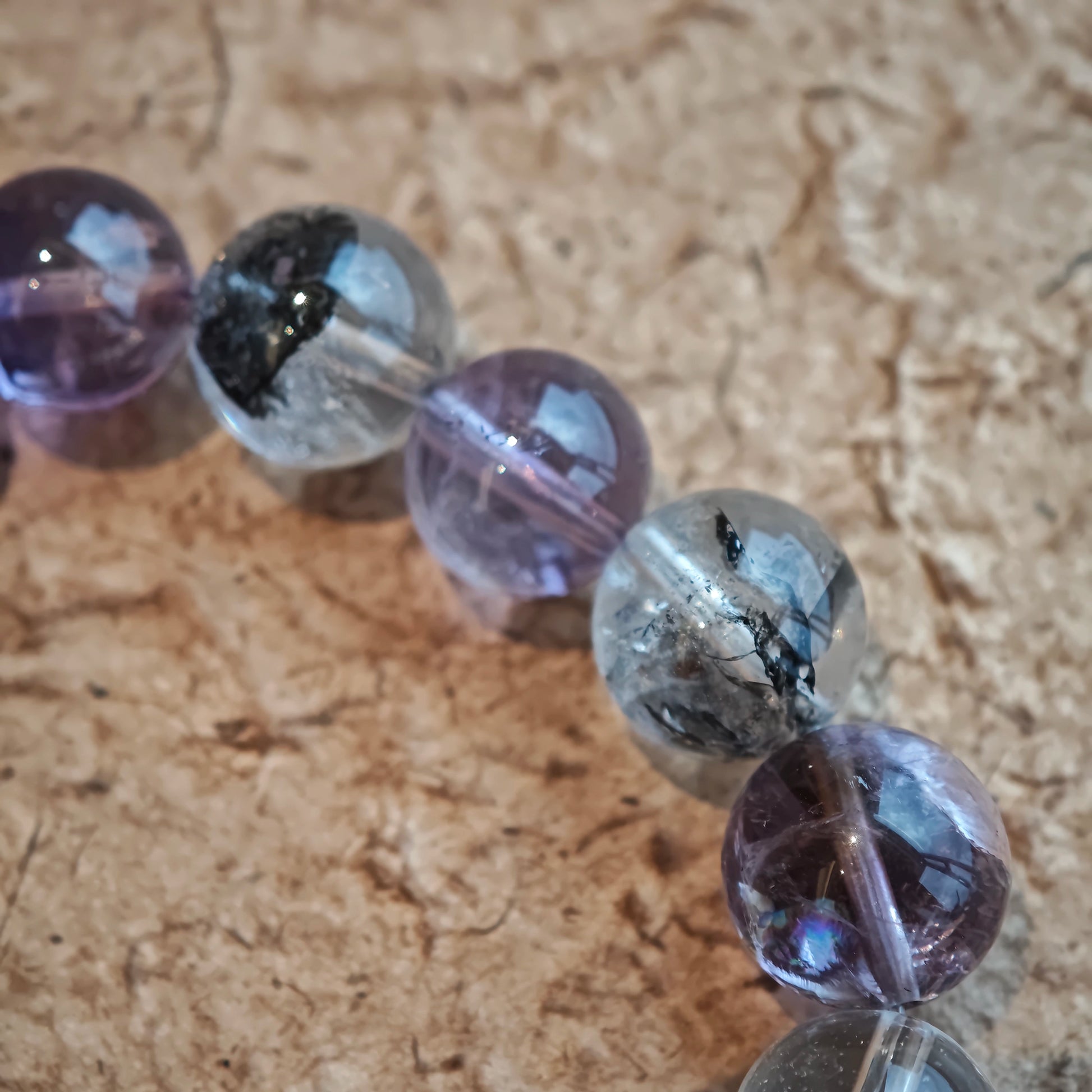 An amethyst bracelet accented with herkimer diamond, clear quartz and silver sheen obsidian.