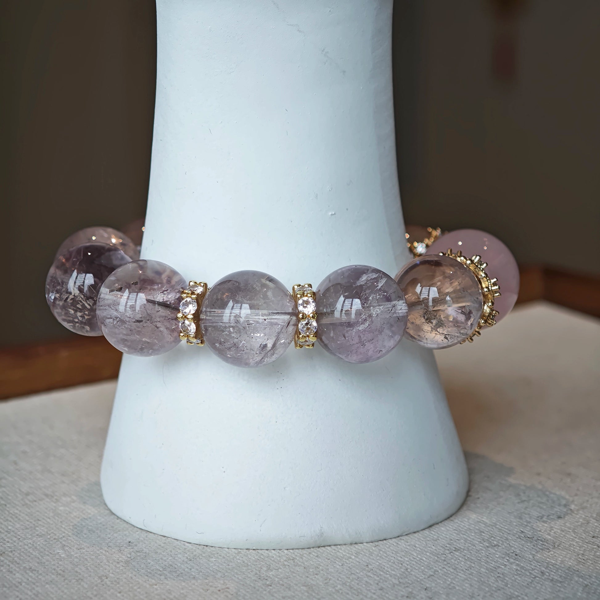 This is a bracelet featuring high-clarity amethyst, rose quartz, and citrine. It's an elegant look of pure peace.