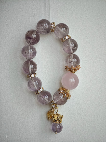 This is a bracelet featuring high-clarity amethyst, rose quartz, and citrine. It's an elegant look of pure peace.