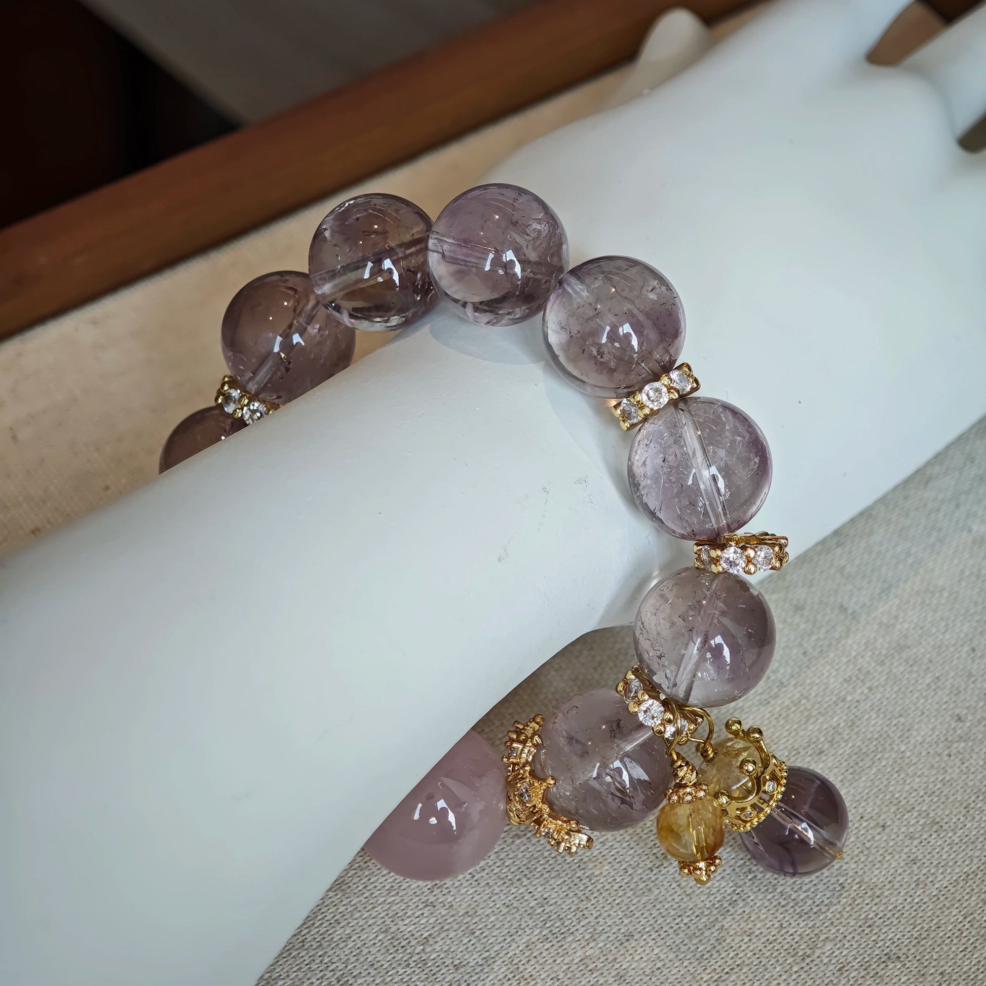 This is a bracelet featuring high-clarity amethyst, rose quartz, and citrine. It's an elegant look of pure peace.
