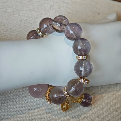 This is a bracelet featuring high-clarity amethyst, rose quartz, and citrine. It's an elegant look of pure peace.