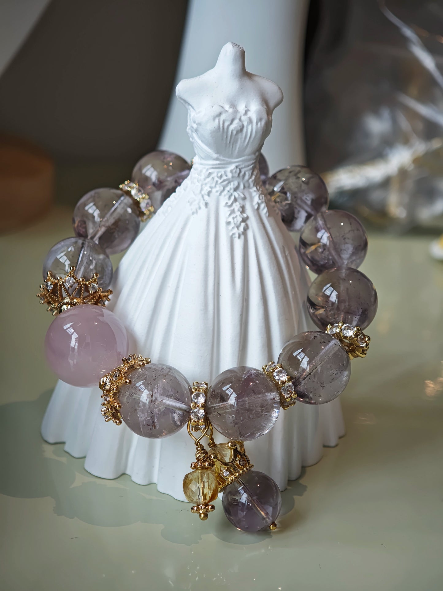 This is a bracelet featuring high-clarity amethyst, rose quartz, and citrine. It's an elegant look of pure peace.