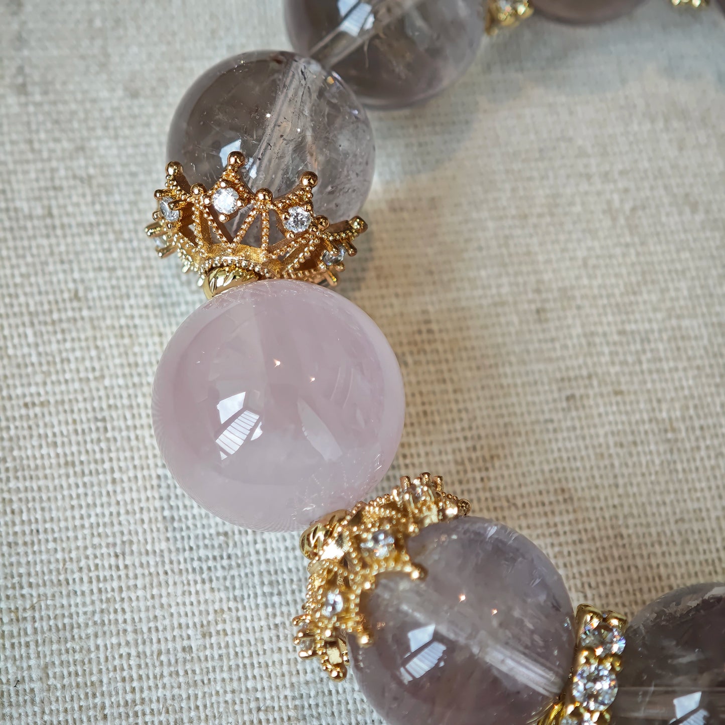 This is a bracelet featuring high-clarity amethyst, rose quartz, and citrine. It's an elegant look of pure peace.
