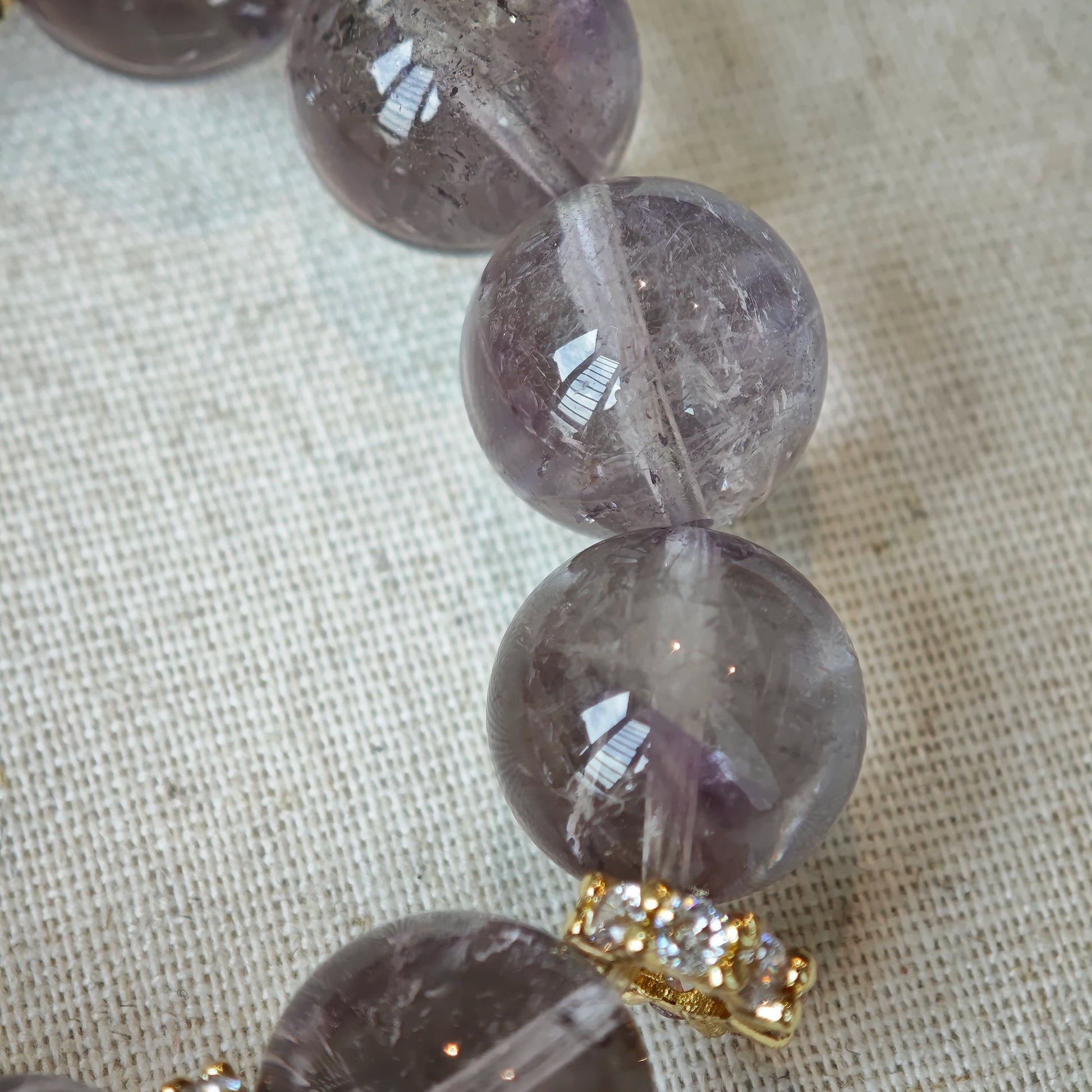 This is a bracelet featuring high-clarity amethyst, rose quartz, and citrine. It's an elegant look of pure peace.