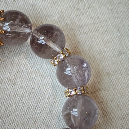 This is a bracelet featuring high-clarity amethyst, rose quartz, and citrine. It's an elegant look of pure peace.