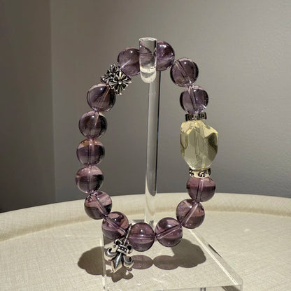 This is a crystal bracelet that consists of amethyst, citrine and chrome hearts spacers.
