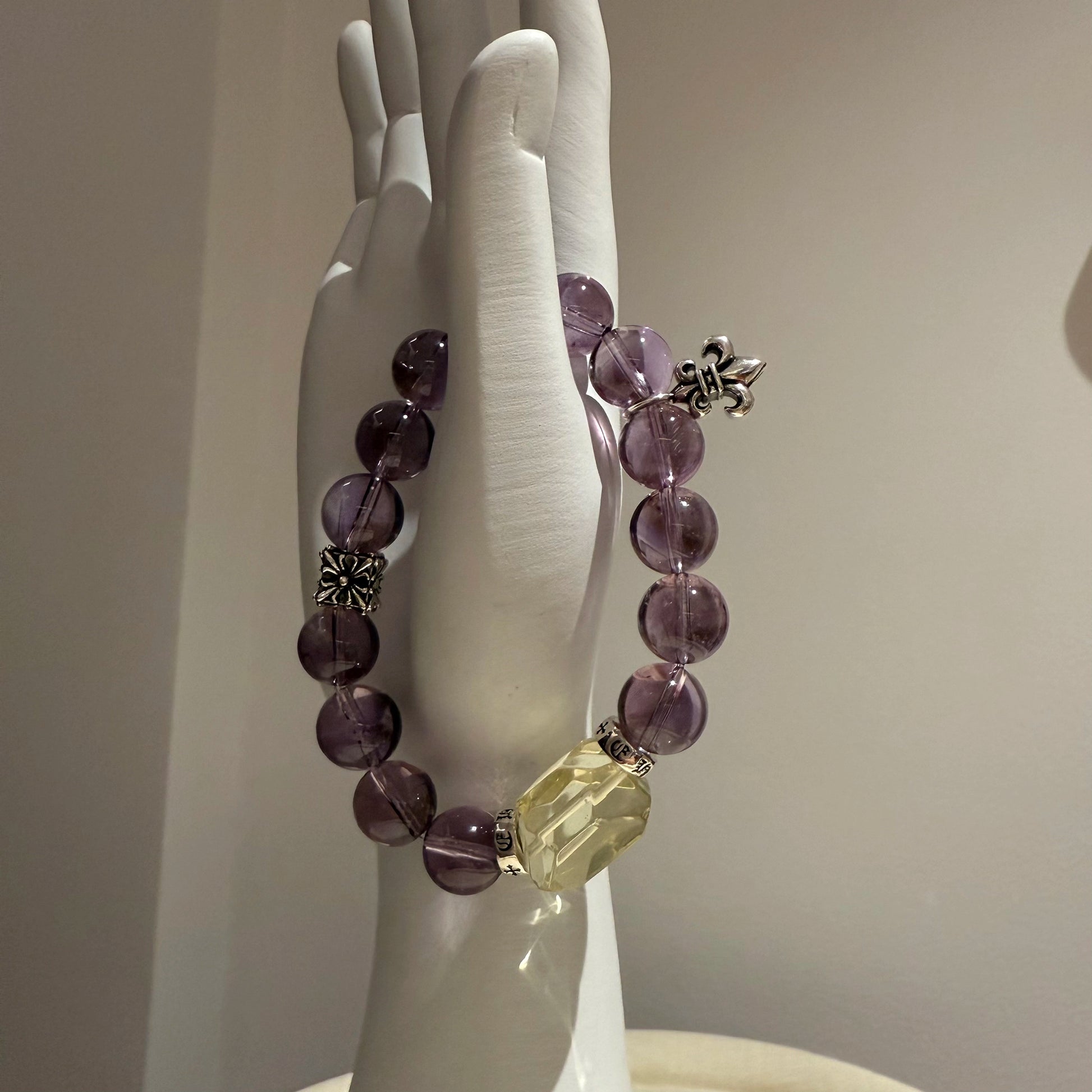 This is a crystal bracelet that consists of amethyst, citrine and chrome hearts spacers.