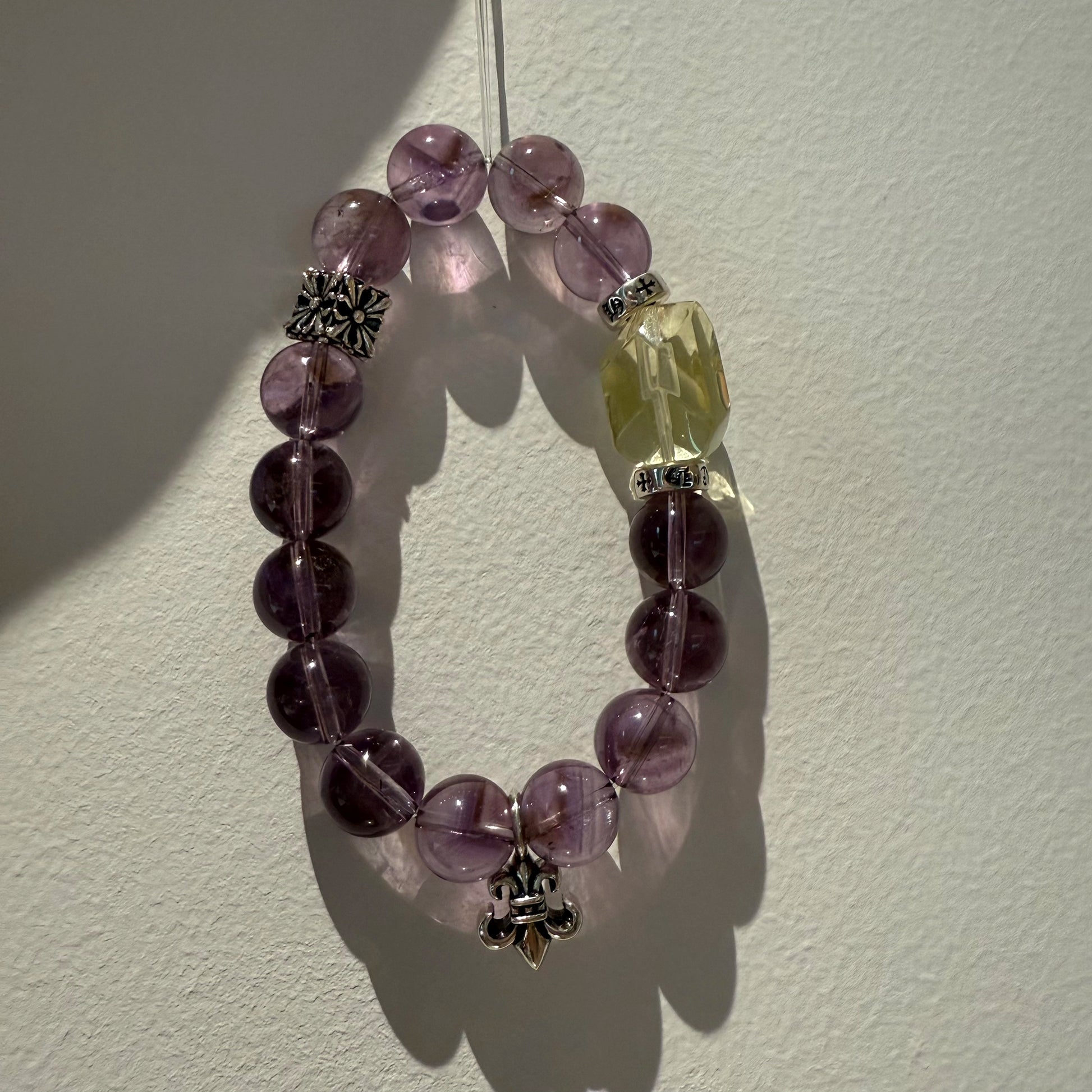 This is a crystal bracelet that consists of amethyst, citrine and chrome hearts spacers.