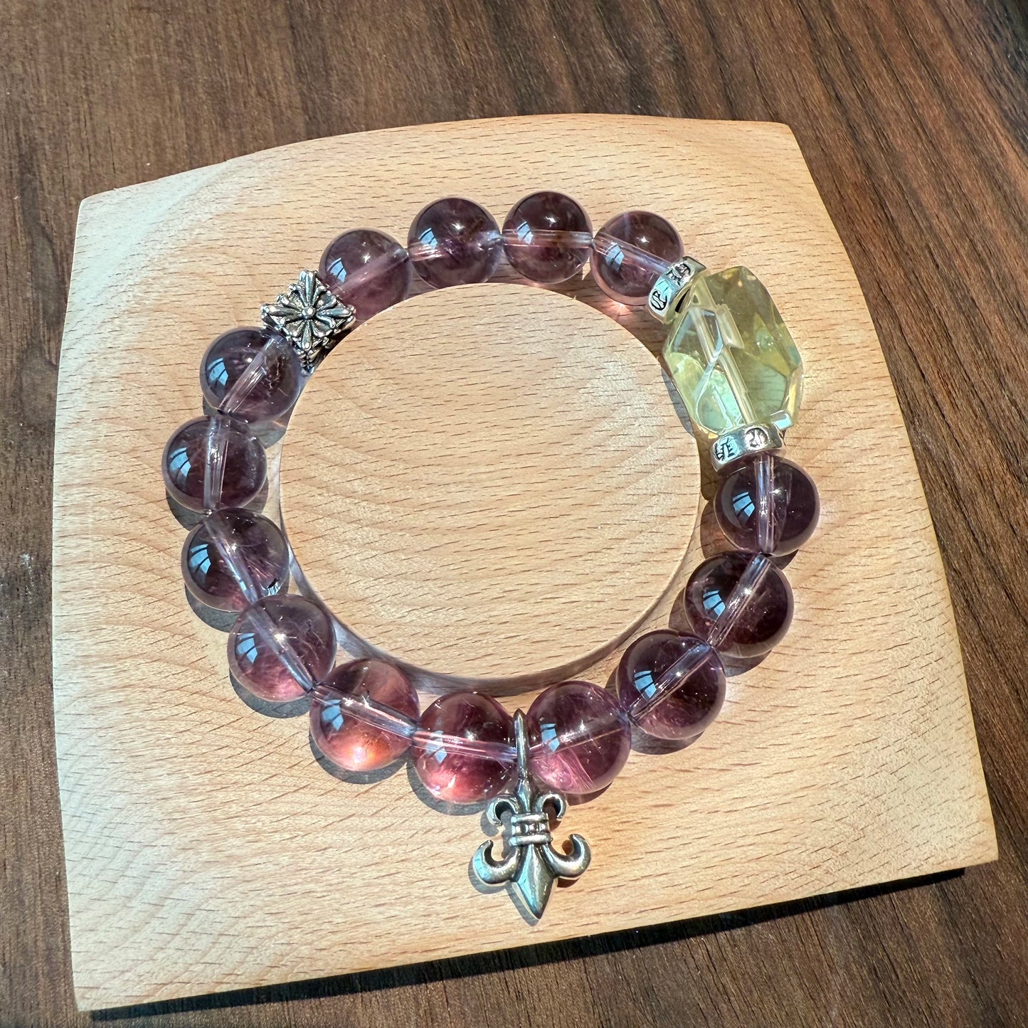 This is a crystal bracelet that consists of amethyst, citrine and chrome hearts spacers.