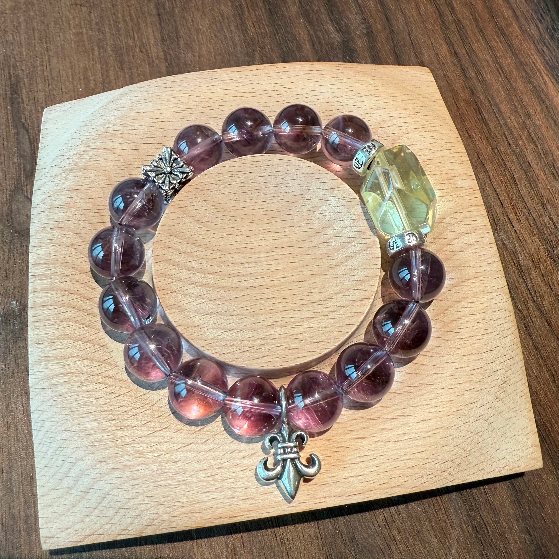 This is a crystal bracelet that consists of amethyst, citrine and chrome hearts spacers.