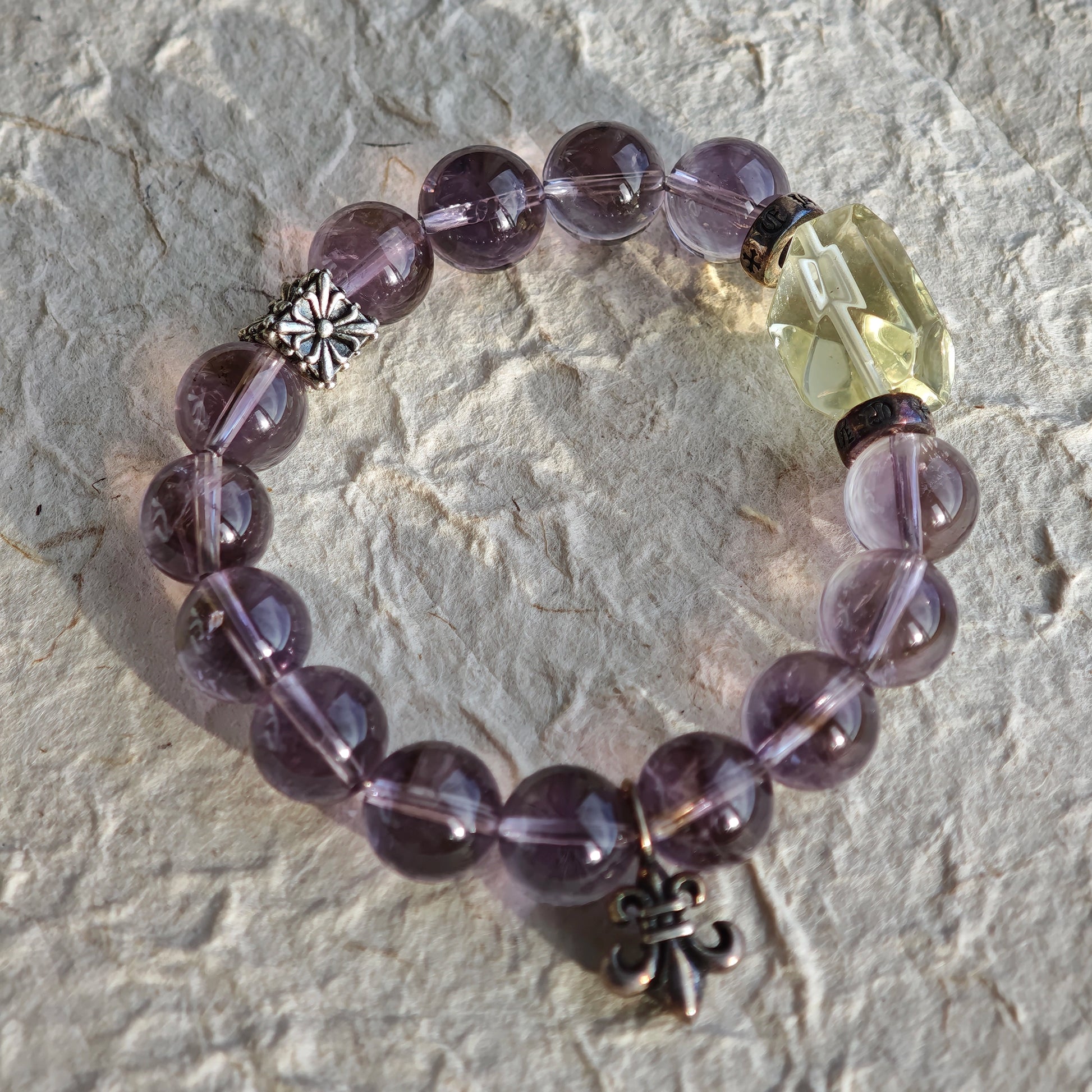 This is a crystal bracelet that consists of amethyst, citrine and chrome hearts spacers.