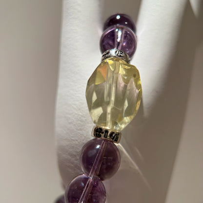 This is a crystal bracelet that consists of amethyst, citrine and chrome hearts spacers.