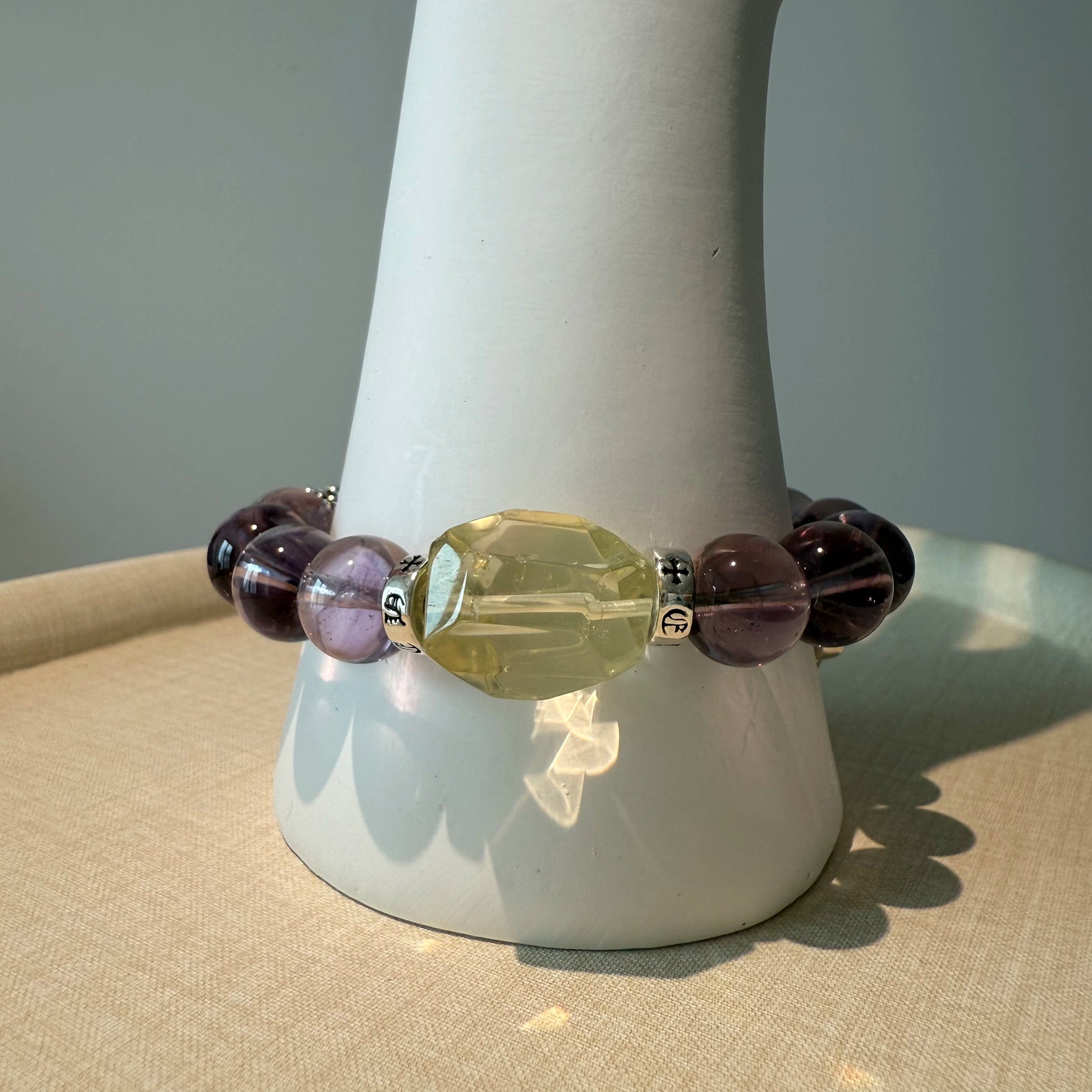 This is a crystal bracelet that consists of amethyst, citrine and chrome hearts spacers.