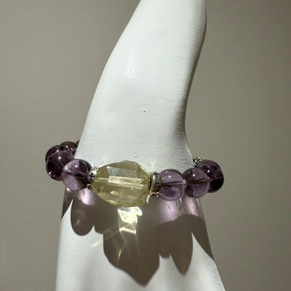 This is a crystal bracelet that consists of amethyst, citrine and chrome hearts spacers.
