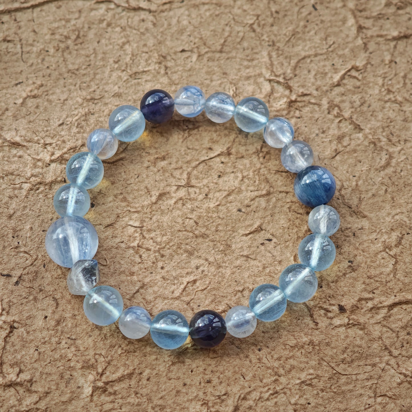 This is a gemstone bracelet consists of Kyanite, Blue Velvet Stone, Aquamarine, and Cordierite.