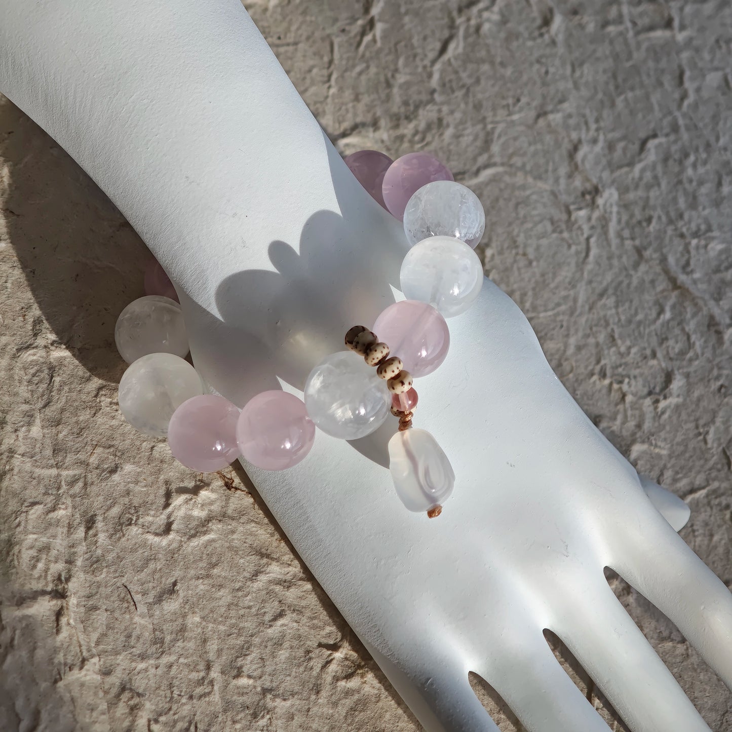 Adorning your wrist: Rose Quartz, White Phantom Quartz, and an agate rabbit on the move.