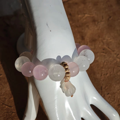 A crystal trio of Rose Quartz, White Phantom Quartz, and an agate rabbit bead forms this bracelet.