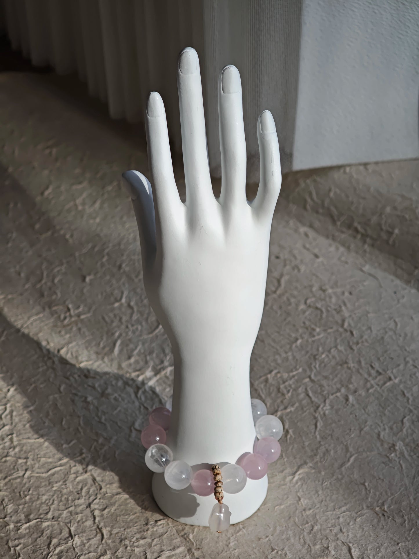 Rose Quartz hearts, White Phantom Quartz clouds, and an agate rabbit charm circle your wrist.