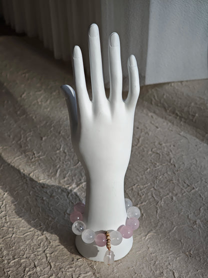 Rose Quartz hearts, White Phantom Quartz clouds, and an agate rabbit charm circle your wrist.