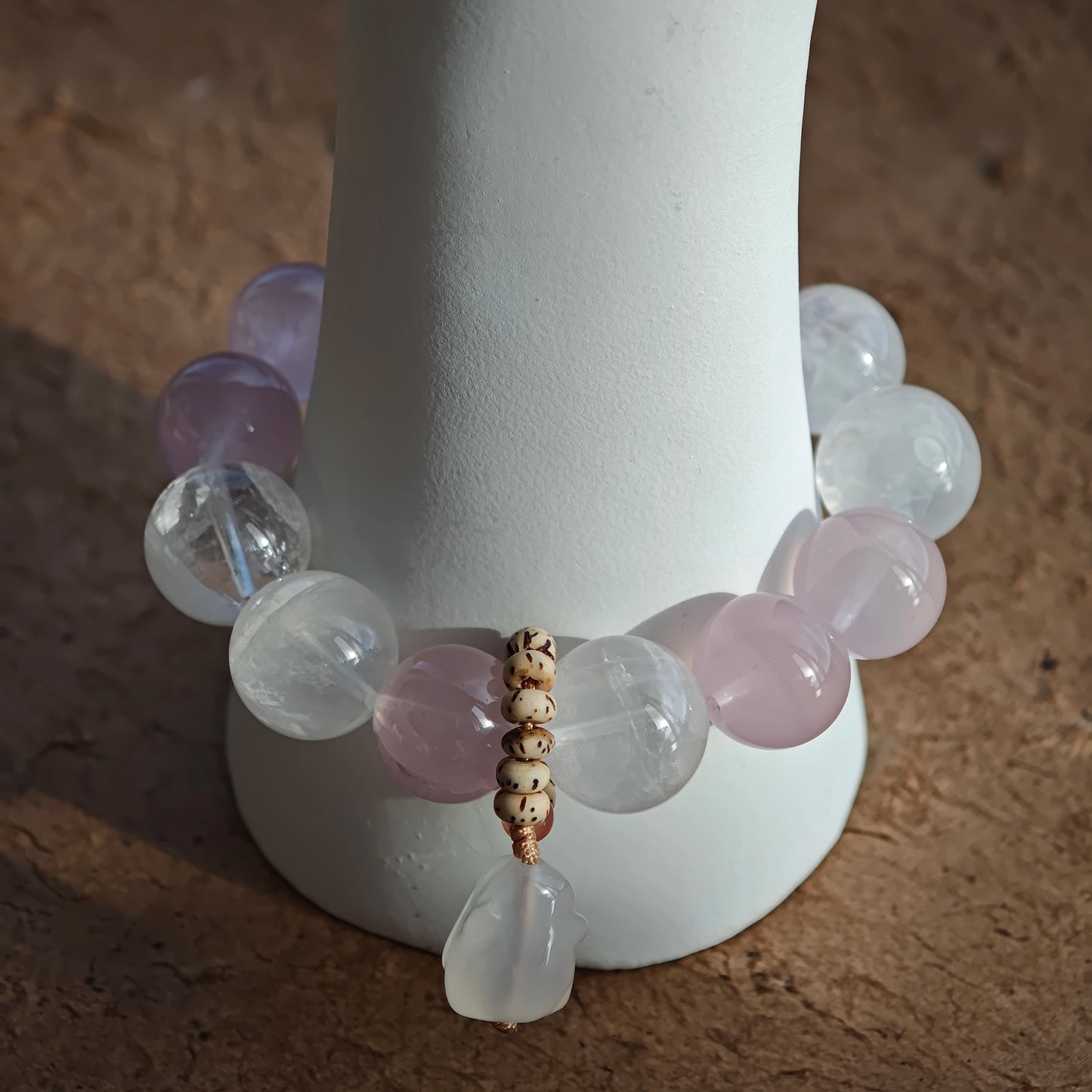 Wear Rose Quartz love, White Phantom Quartz insight, and an agate rabbit companion in one bracelet.