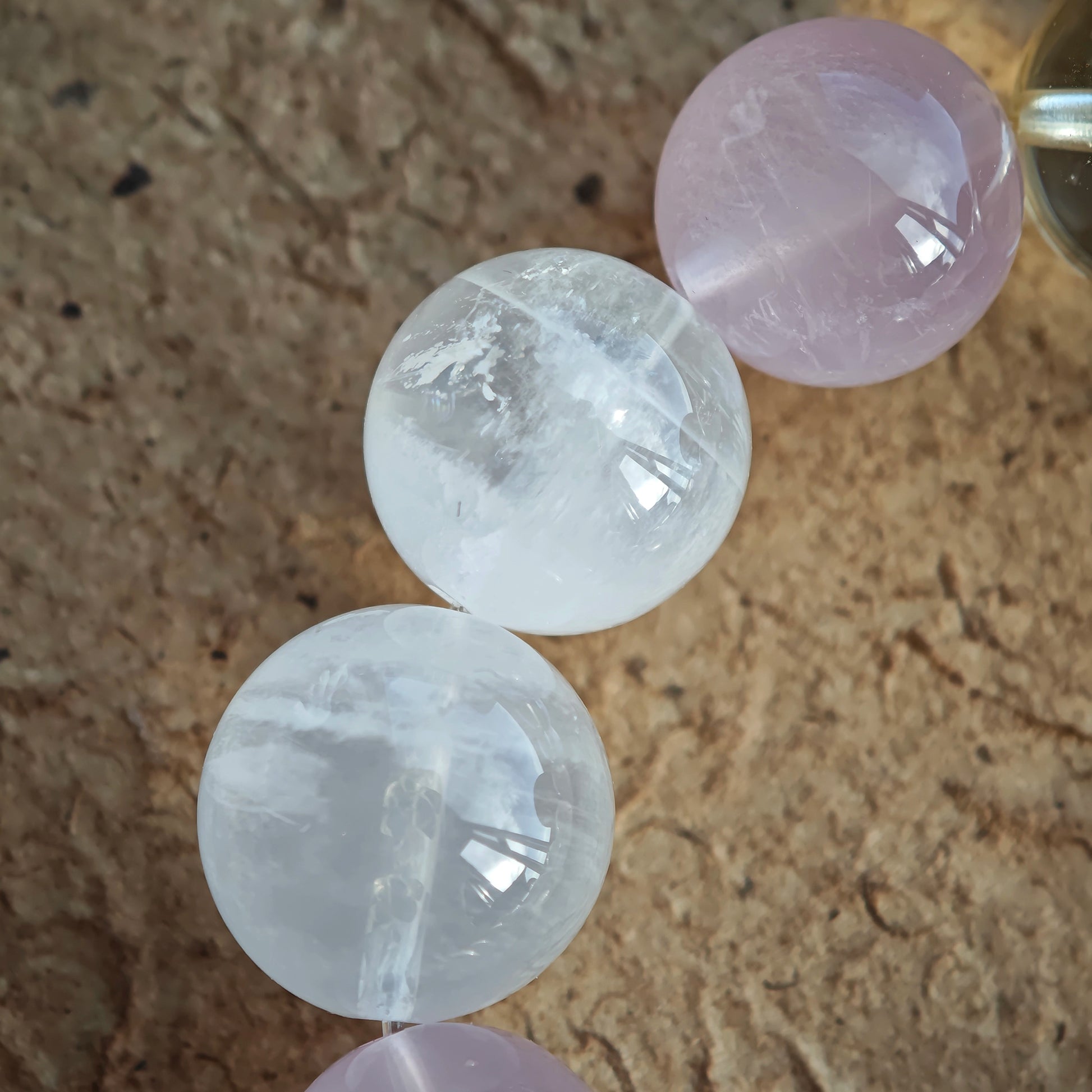 This crystal strand showcases Rose Quartz, White Phantom Quartz, and an agate rabbit bead.