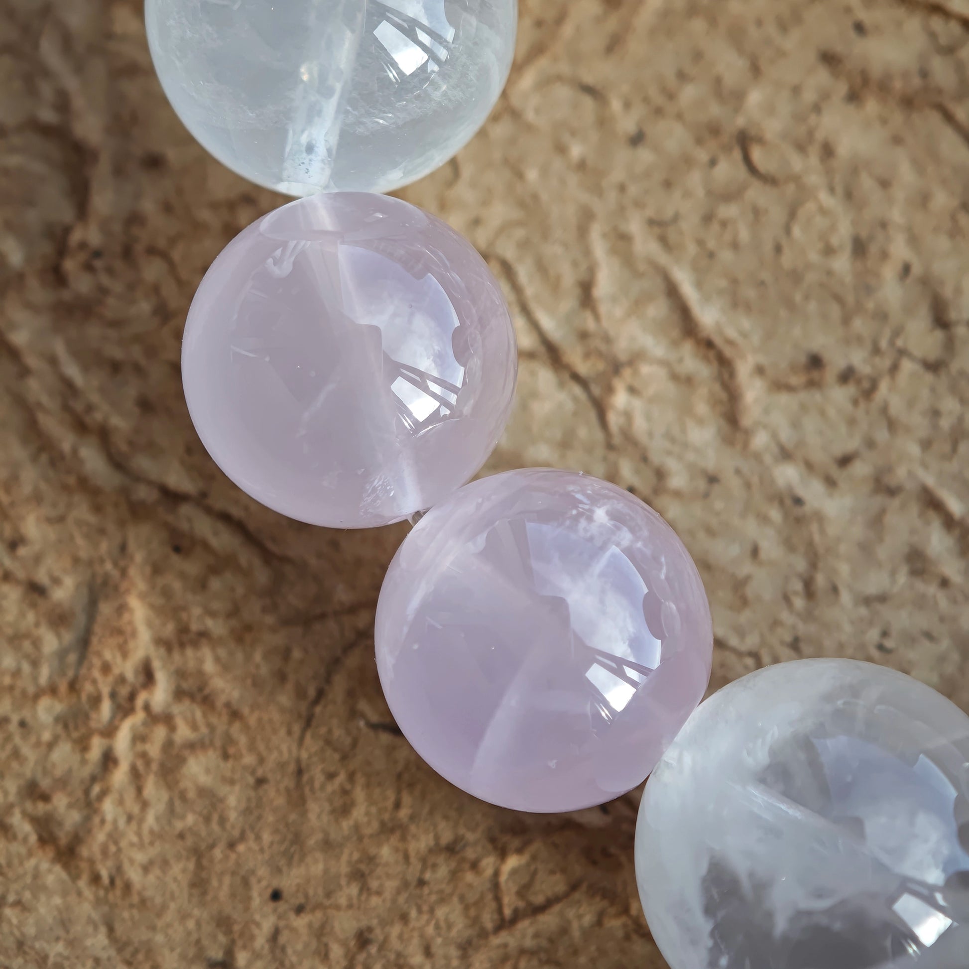 A delicate fusion of Rose Quartz, White Phantom Quartz, and an agate bunny bead graces this bracelet.