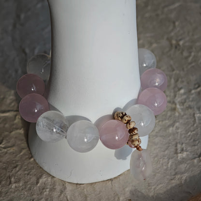 The bracelet strings together Rose Quartz, White Phantom Quartz, and an agate rabbit slider.
