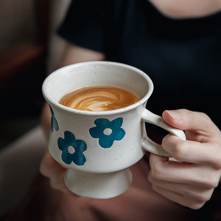 This is a 300ml ceramic goblet mug with hand-painted leaf or flower patterns and a matte sesame-speckled glaze design. With mouth diameter of 9.7, bottom diameter of 6.7cm and height of 10.5cm, this mug is ideal for coffee, milk, water, or oatmeal during slow mornings or quiet afternoons.