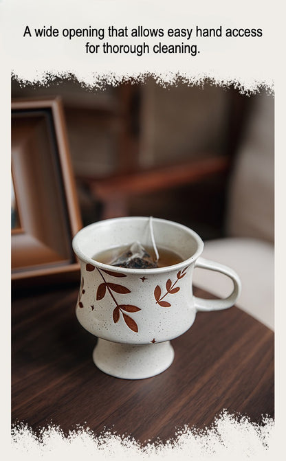 This is a 300ml ceramic goblet mug with hand-painted leaf or flower patterns and a matte sesame-speckled glaze design. With mouth diameter of 9.7, bottom diameter of 6.7cm and height of 10.5cm, this mug is ideal for coffee, milk, water, or oatmeal during slow mornings or quiet afternoons.