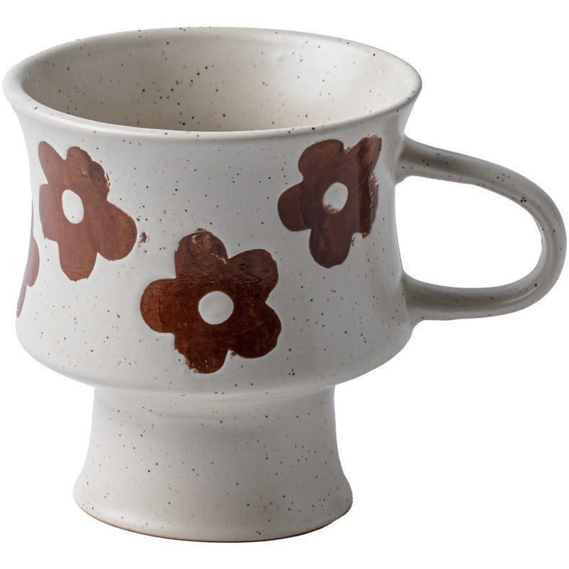 This is a 300ml ceramic goblet mug with hand-painted leaf or flower patterns and a matte sesame-speckled glaze design. With mouth diameter of 9.7, bottom diameter of 6.7cm and height of 10.5cm, this mug is ideal for coffee, milk, water, or oatmeal during slow mornings or quiet afternoons.
