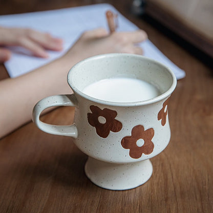 This is a 300ml ceramic goblet mug with hand-painted leaf or flower patterns and a matte sesame-speckled glaze design. With mouth diameter of 9.7, bottom diameter of 6.7cm and height of 10.5cm, this mug is ideal for coffee, milk, water, or oatmeal during slow mornings or quiet afternoons.