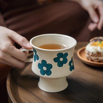 This is a 300ml ceramic goblet mug with hand-painted leaf or flower patterns and a matte sesame-speckled glaze design. With mouth diameter of 9.7, bottom diameter of 6.7cm and height of 10.5cm, this mug is ideal for coffee, milk, water, or oatmeal during slow mornings or quiet afternoons.
