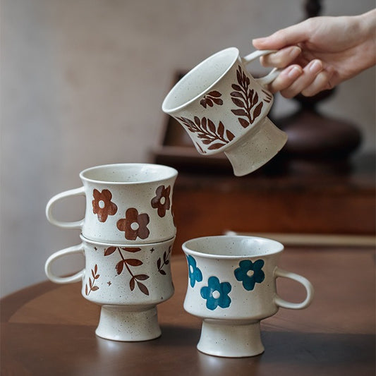 This is a 300ml ceramic goblet mug with hand-painted leaf or flower patterns and a matte sesame-speckled glaze design. With mouth diameter of 9.7, bottom diameter of 6.7cm and height of 10.5cm, this mug is ideal for coffee, milk, water, or oatmeal during slow mornings or quiet afternoons.