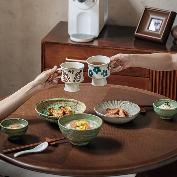 This is a 300ml ceramic goblet mug with hand-painted leaf or flower patterns and a matte sesame-speckled glaze design. With mouth diameter of 9.7, bottom diameter of 6.7cm and height of 10.5cm, this mug is ideal for coffee, milk, water, or oatmeal during slow mornings or quiet afternoons.