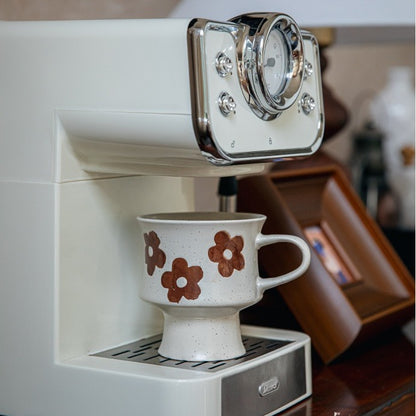 This is a 300ml ceramic goblet mug with hand-painted leaf or flower patterns and a matte sesame-speckled glaze design. With mouth diameter of 9.7, bottom diameter of 6.7cm and height of 10.5cm, this mug is ideal for coffee, milk, water, or oatmeal during slow mornings or quiet afternoons.