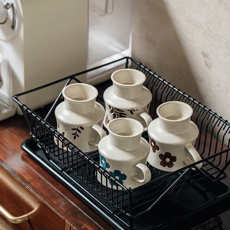 This is a 300ml ceramic goblet mug with hand-painted leaf or flower patterns and a matte sesame-speckled glaze design. With mouth diameter of 9.7, bottom diameter of 6.7cm and height of 10.5cm, this mug is ideal for coffee, milk, water, or oatmeal during slow mornings or quiet afternoons.