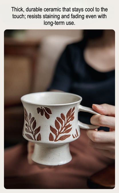 This is a 300ml ceramic goblet mug with hand-painted leaf or flower patterns and a matte sesame-speckled glaze design. With mouth diameter of 9.7, bottom diameter of 6.7cm and height of 10.5cm, this mug is ideal for coffee, milk, water, or oatmeal during slow mornings or quiet afternoons.