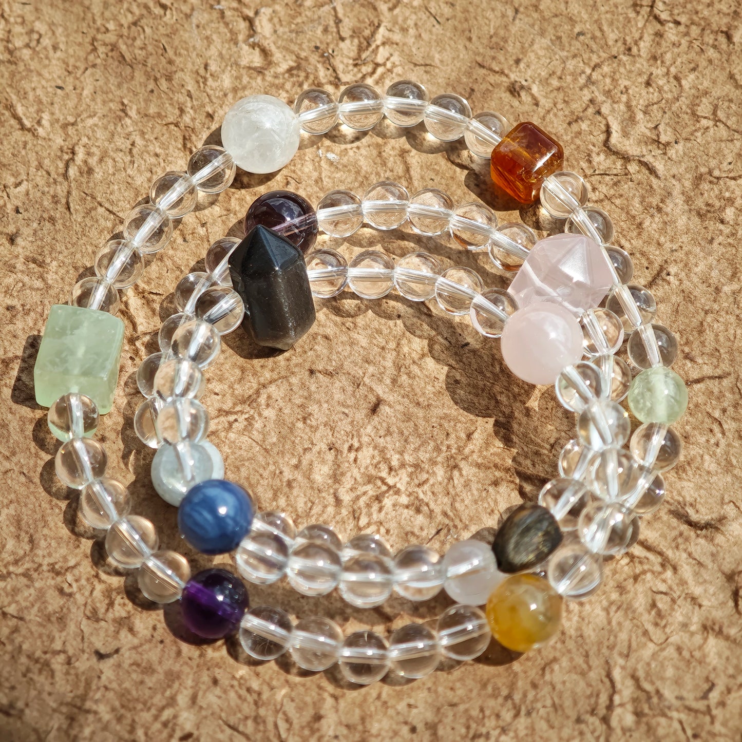 A multi-gemstone bracelet which is made with Silver Sheen Obsidian, Clear Quartz, Amethyst, Rose Quartz, Kyanite, Citrine, and Prehnite, etc. It’s also a necklace.