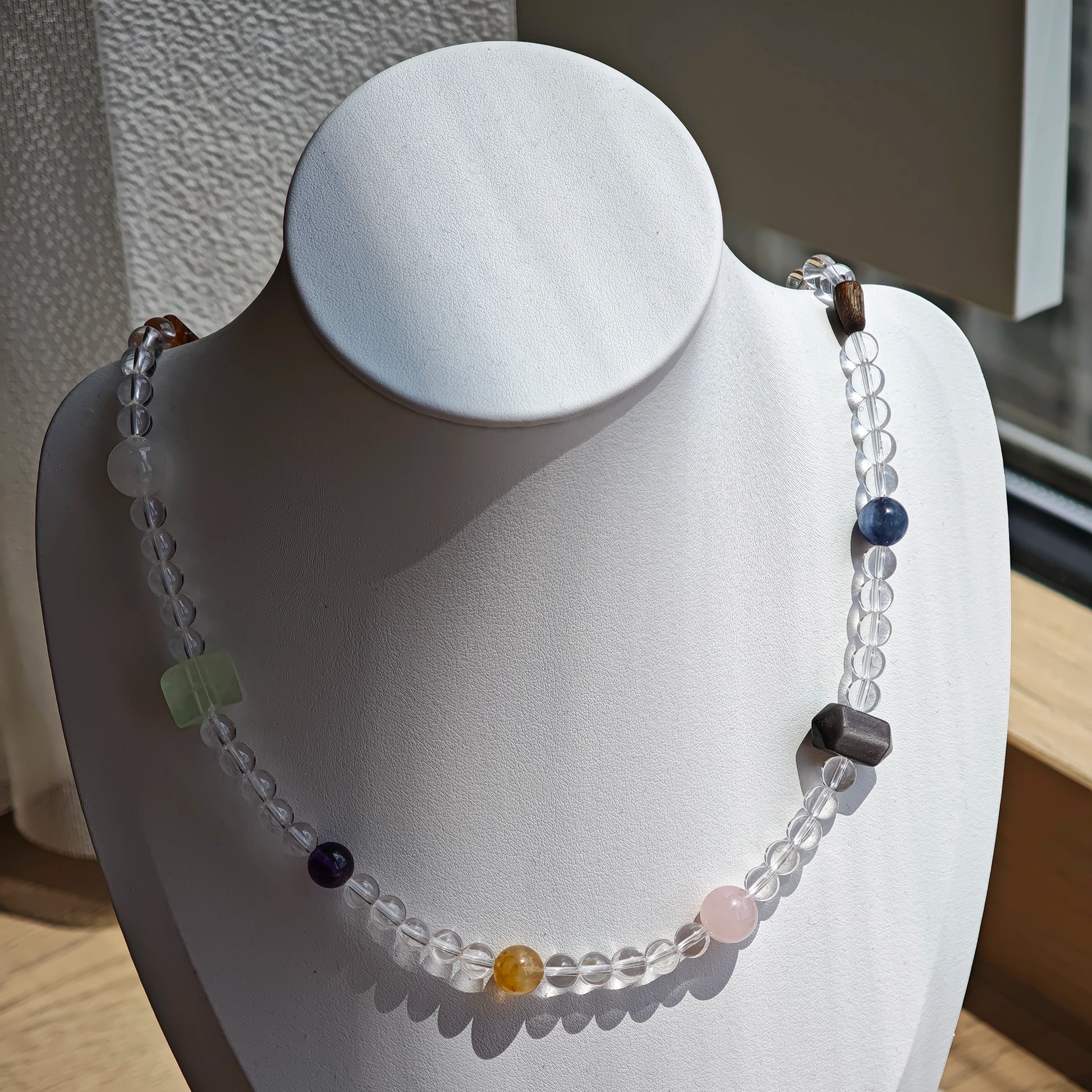 A multi-gemstone bracelet which is made with Silver Sheen Obsidian, Clear Quartz, Amethyst, Rose Quartz, Kyanite, Citrine, and Prehnite, etc. It’s also a necklace.