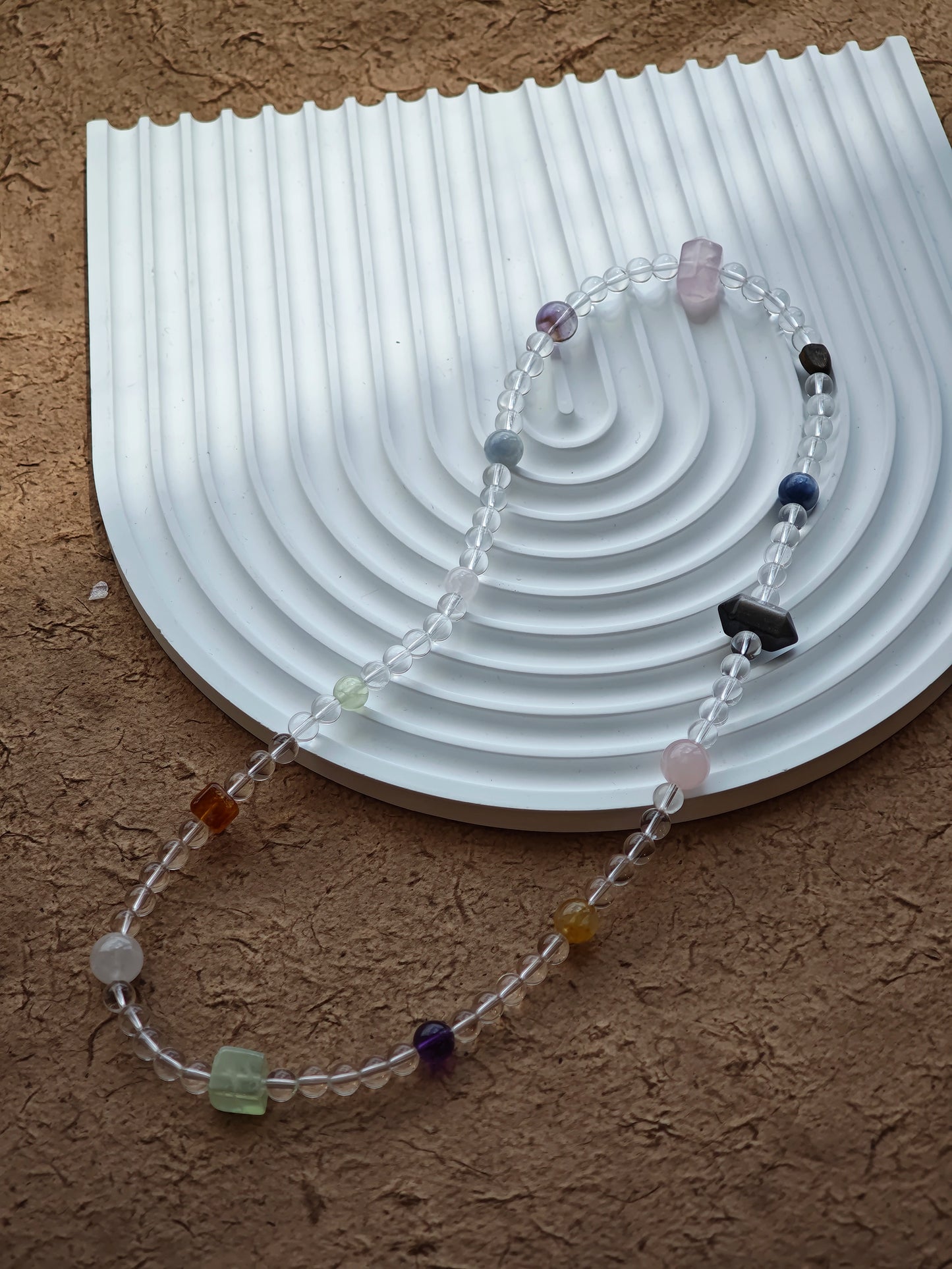 A multi-gemstone bracelet which is made with Silver Sheen Obsidian, Clear Quartz, Amethyst, Rose Quartz, Kyanite, Citrine, and Prehnite, etc. It’s also a necklace.