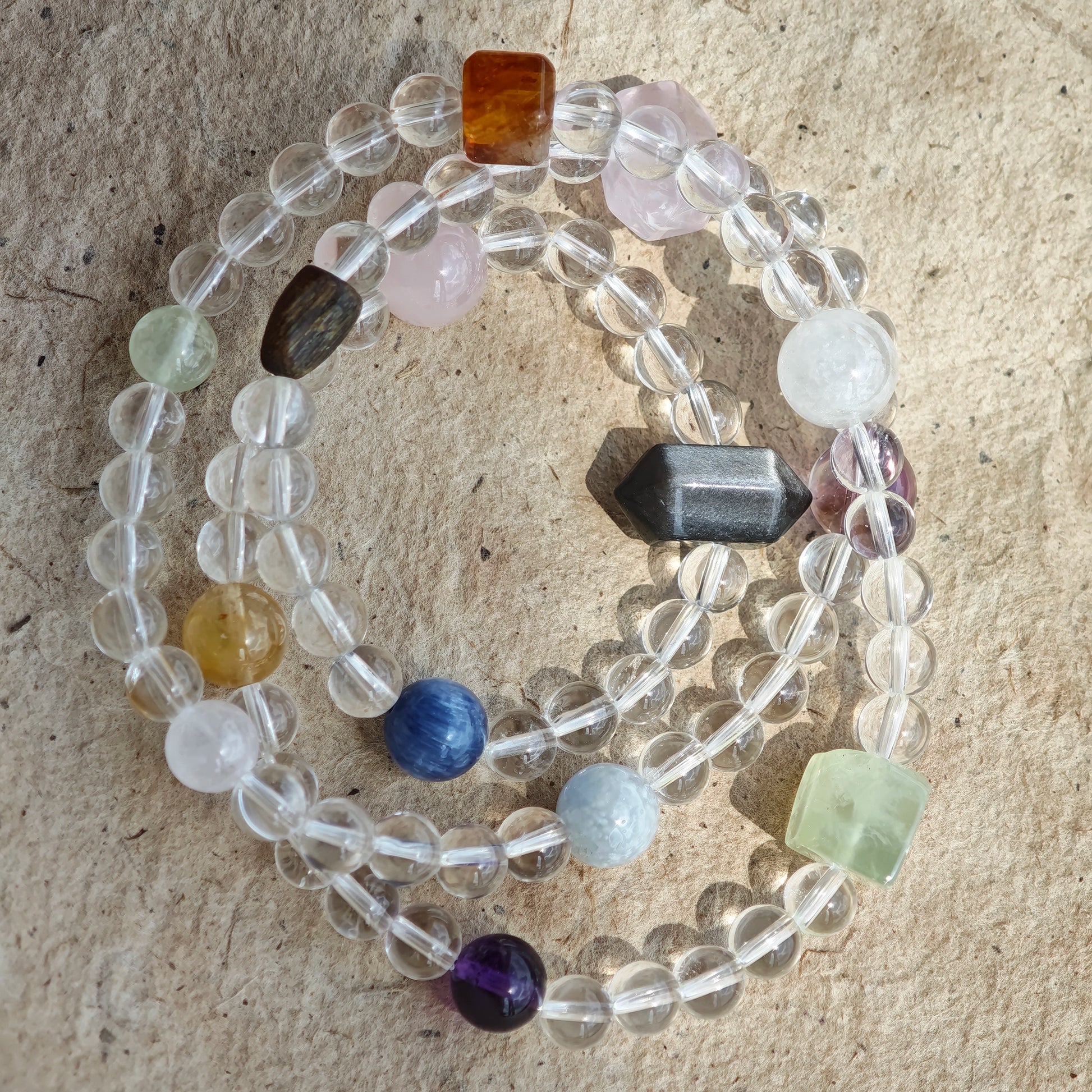 A multi-gemstone bracelet which is made with Silver Sheen Obsidian, Clear Quartz, Amethyst, Rose Quartz, Kyanite, Citrine, and Prehnite, etc. It’s also a necklace.