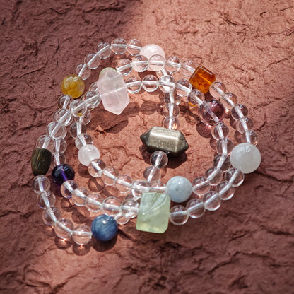 A multi-gemstone bracelet which is made with Silver Sheen Obsidian, Clear Quartz, Amethyst, Rose Quartz, Kyanite, Citrine, and Prehnite, etc. It’s also a necklace.