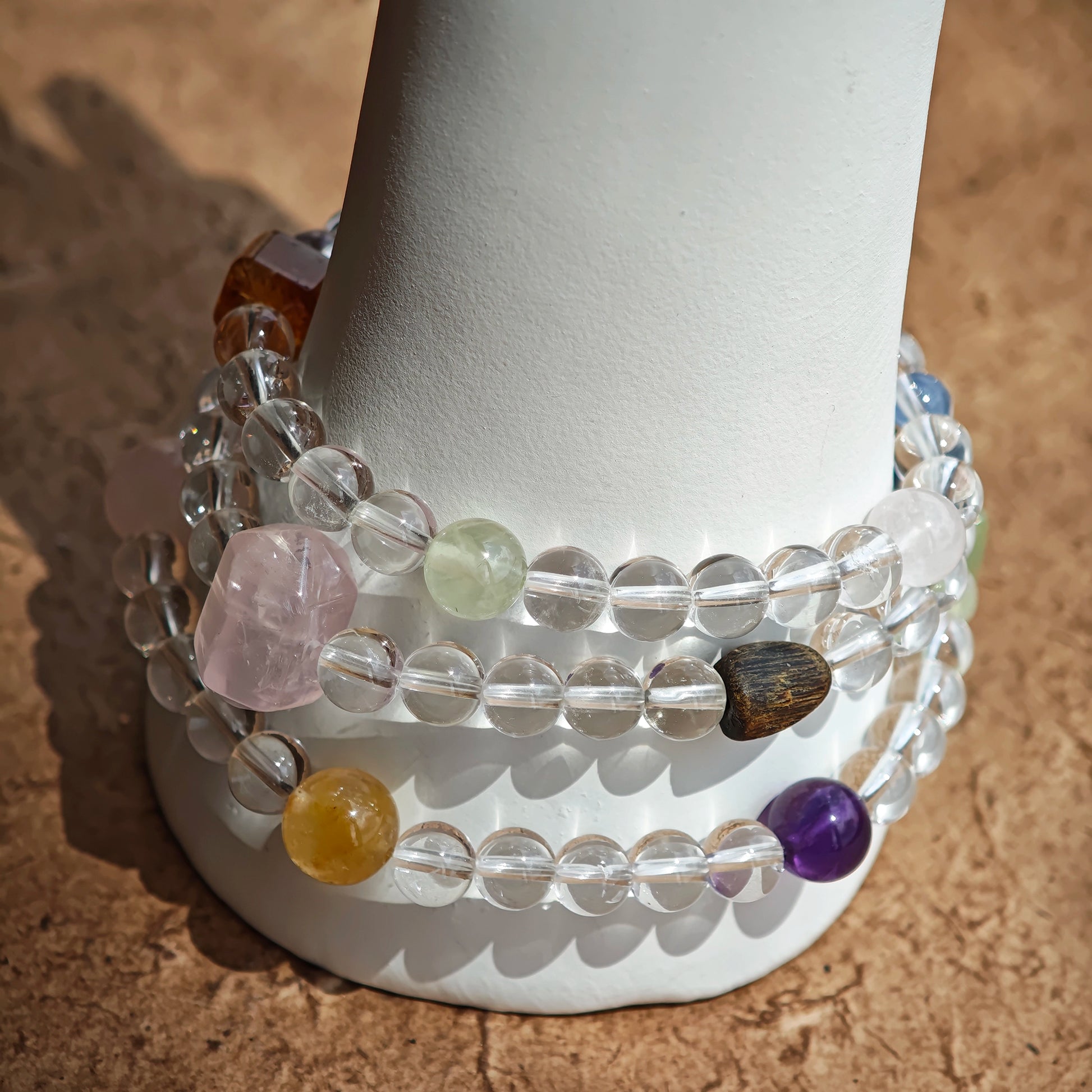A multi-gemstone bracelet which is made with Silver Sheen Obsidian, Clear Quartz, Amethyst, Rose Quartz, Kyanite, Citrine, and Prehnite, etc. It’s also a necklace.