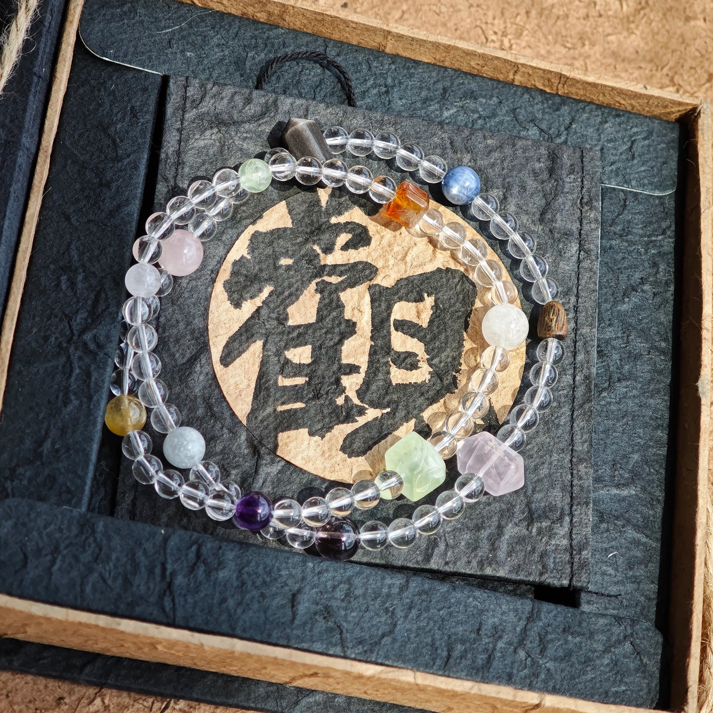 A multi-gemstone bracelet which is made with Silver Sheen Obsidian, Clear Quartz, Amethyst, Rose Quartz, Kyanite, Citrine, and Prehnite, etc. It’s also a necklace.