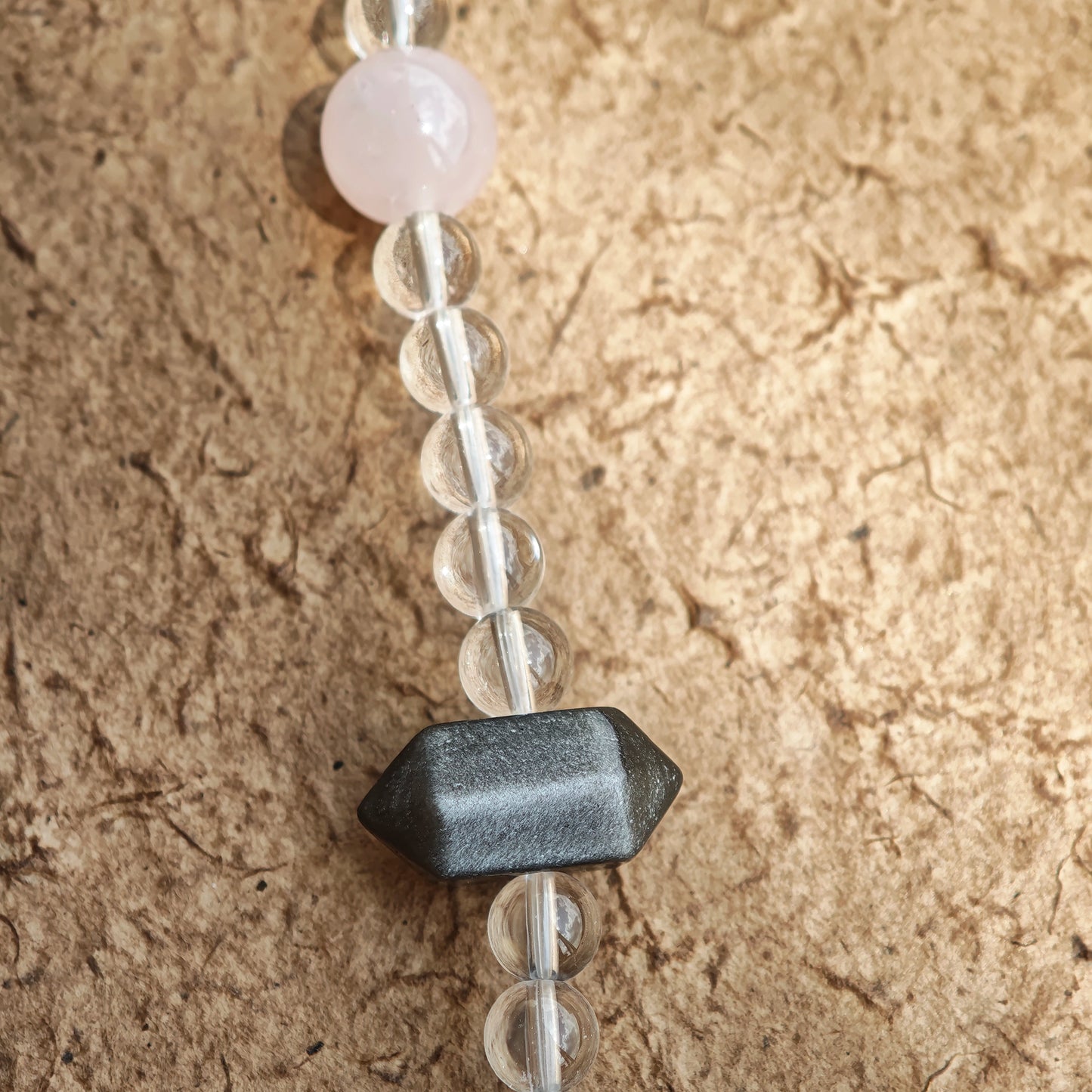 A multi-gemstone bracelet which is made with Silver Sheen Obsidian, Clear Quartz, Amethyst, Rose Quartz, Kyanite, Citrine, and Prehnite, etc. It’s also a necklace.